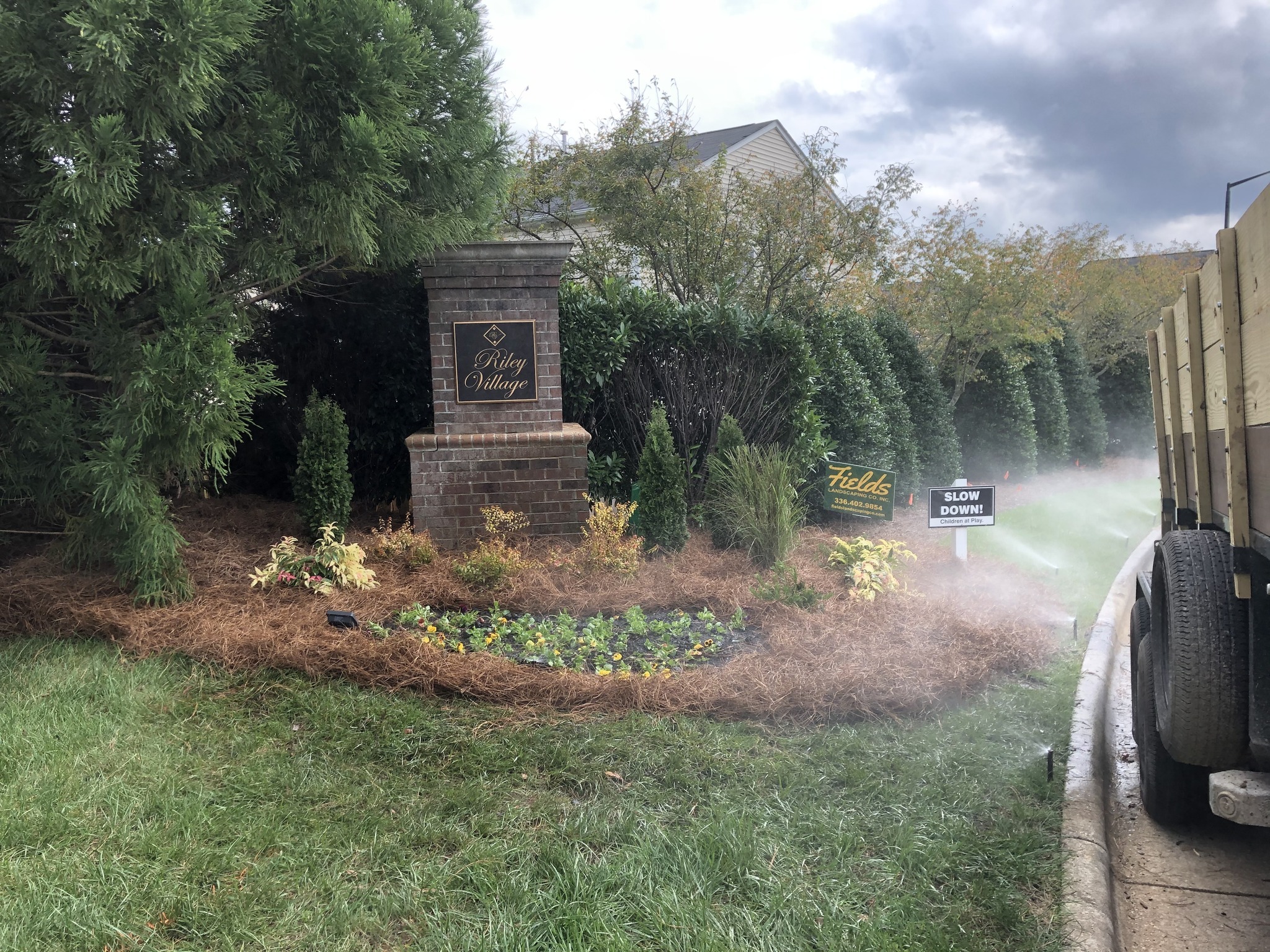 Riley Village entrance landscaping watered by sprinklers