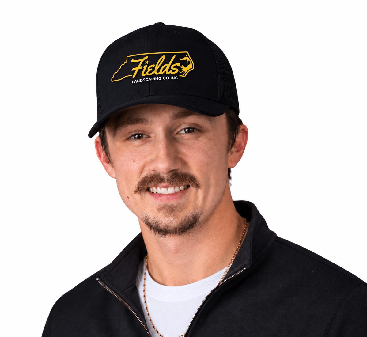 Smiling landscaper wearing Fields Landscaping Co Inc cap