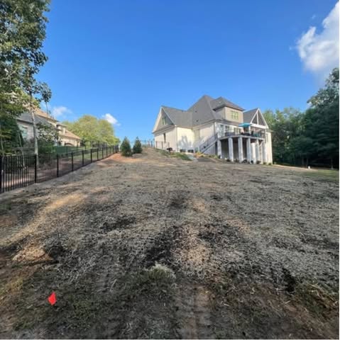 Large house overlooking newly cleared backyard