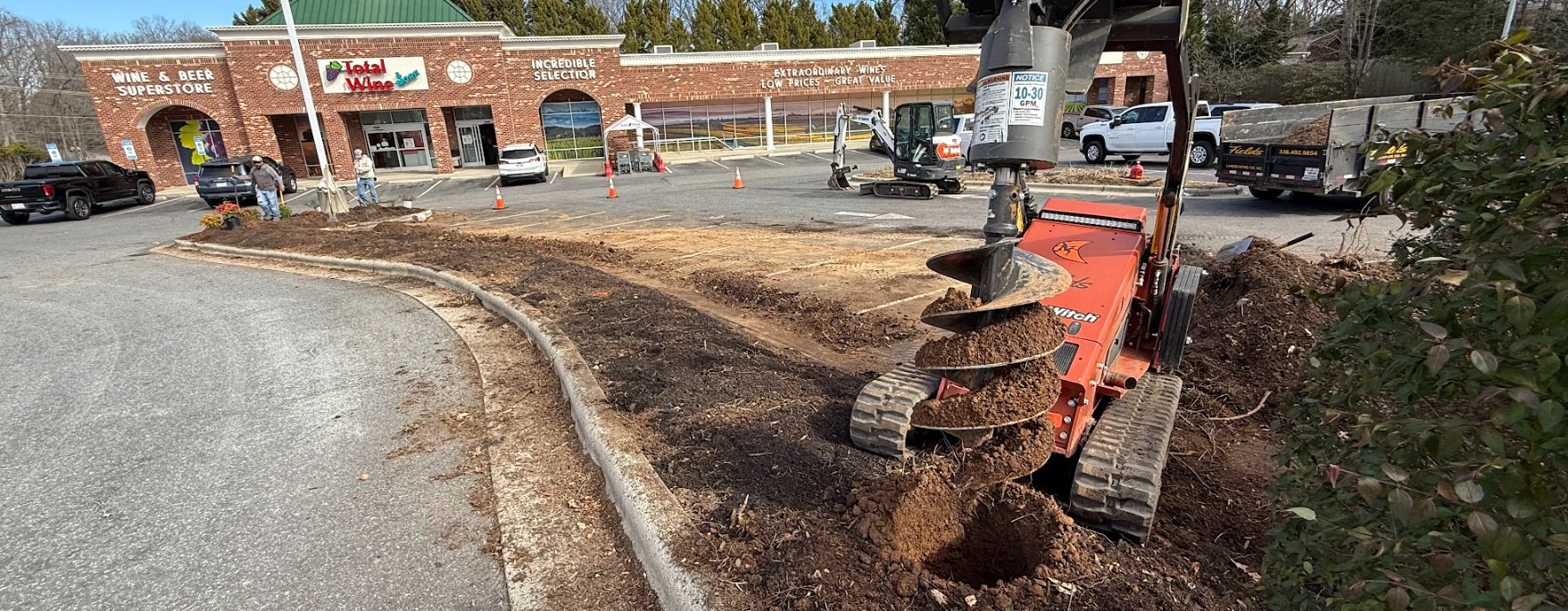 Auger drilling outside Total Wine store during landscaping work